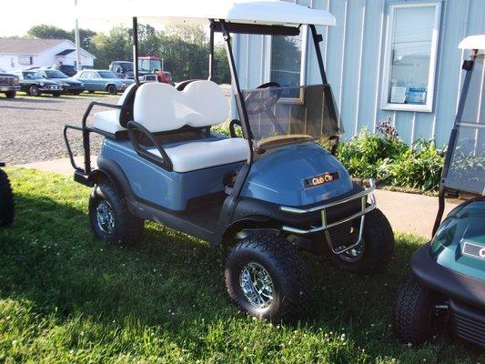 Club Car with lift kit, rear seat, extended roof & brush guard