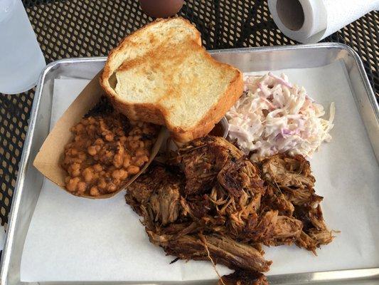 Pulled pork platter with coleslaw and baked beans.