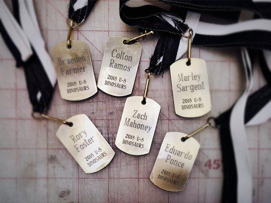 Engraved medals with coordinated neck ribbons for a soccer team to celebrate their accomplishments over the course of their season!