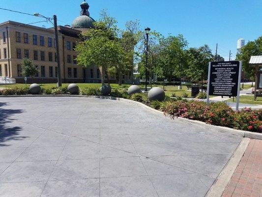 Landscaping by entrance with several benches.