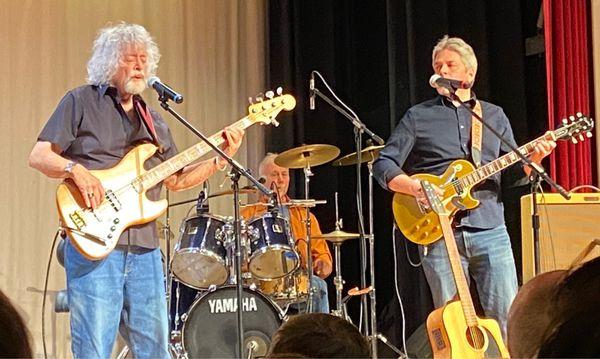 Big John Wallace (bass), Howie Fields (drums), and Clark Wallace (electric guitar). Harry Chapin Band.