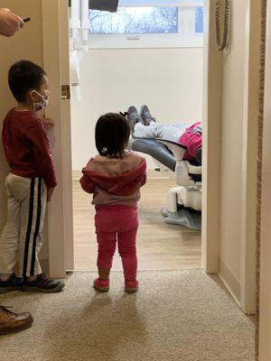 Two little cuties watching their moms dental checkup and learning how all the tools work!