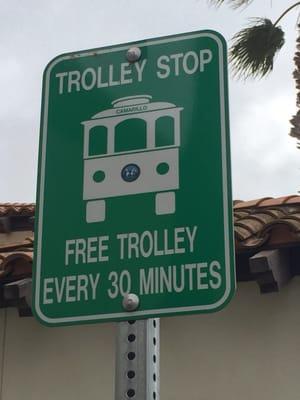 Trolley sign at every stop usually with a bench and small sun shade