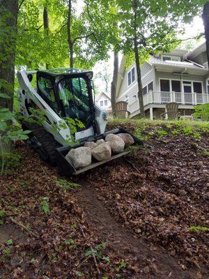 Moving granite to lakefront where we hand set 30+ ton of boulders.