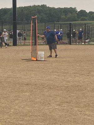 Fat guy throwing BP.