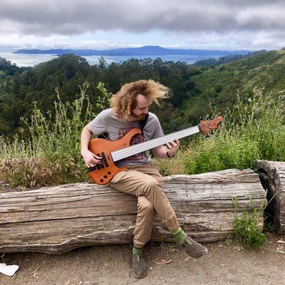 Just a boy on a log, playing bass.