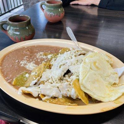 Chilaquiles Verdes with egg, cream, and queso fresco.