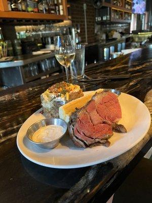 Prime rib and baked potato with everything