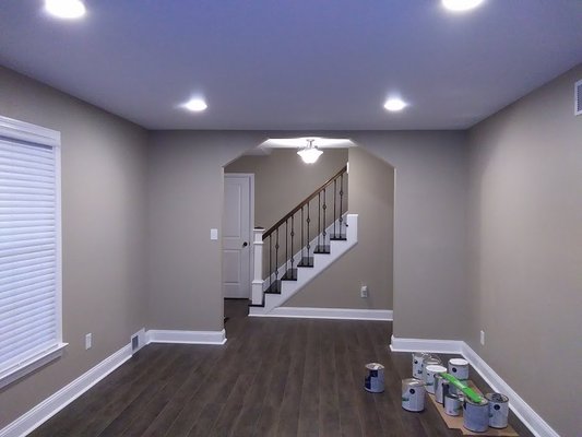 New drywall, baseboards, flooring, recessed lighting, and staircase.