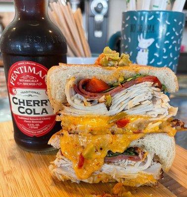 Hot Mess - House-made turkey, capicola, 3 cheese roasted red pepper spread, cherry peppers, arugula