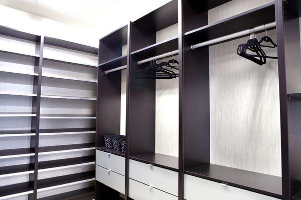 Luxury two-toned custom closets system including shoe shelving, accessory drawers and hanging throughout.