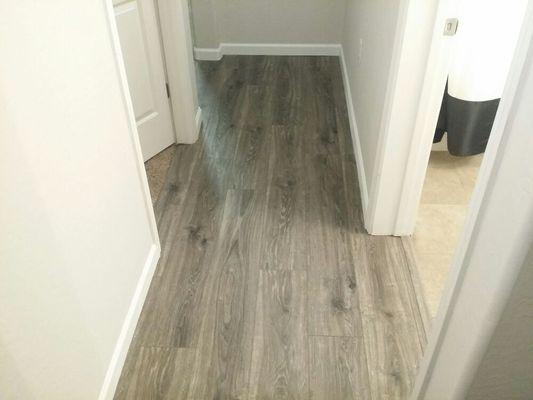 Hallway of remodel with new engineered floor, new baseboard and new paint.