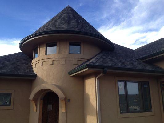 Gutter installed around turret curved roof eave.