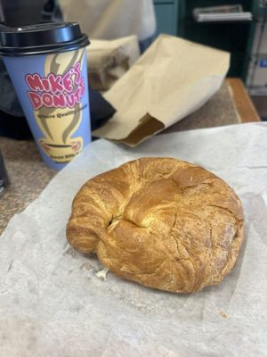 bacon egg and cheese with hashbrown on a croissant, medium cappuccino