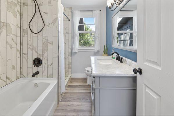 Bathroom after with new flooring, new jetted tub and stall shower new vanity.