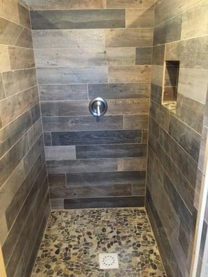 New beautiful tiled shower stall.