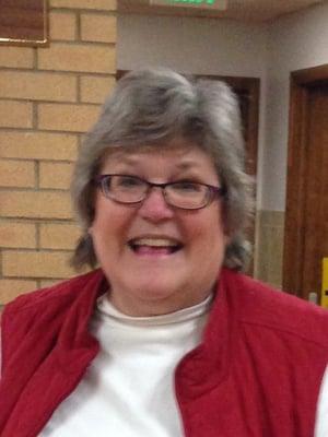 Pastor Barb plays music during chapel with the children.