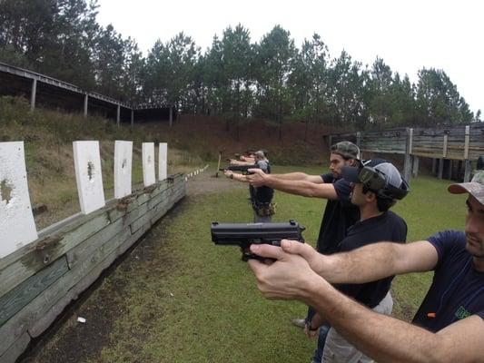 Instructor checking firearm grips.