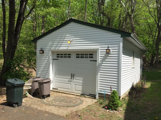 Garage was crashed into with vehicle, knocking right wall off the foundation. fixed foundation, New garage door, new siding.