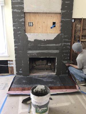 Cody working on my fireplace and bathroom shower floor.