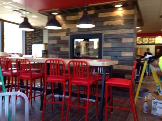 Arby's new look, inside there is a community table and fireplace.