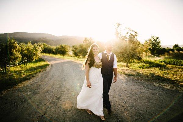 Wedding couple walking down road on the farm.  Photo by Gabriel Harber Photography http://harberphotography.com