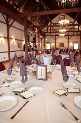 Photo by Brianne Bradbury Photography - the Inside of the barn/banquet room.  There is a fireplace behind the photog.