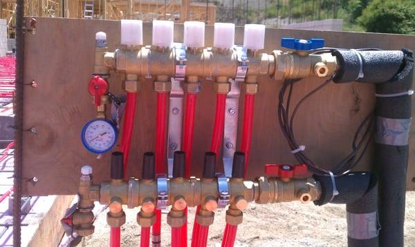 Radiant system manifold, under test, ready for city inspection