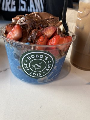 Blue bowl with banana,granola, strawberry and Nutella.