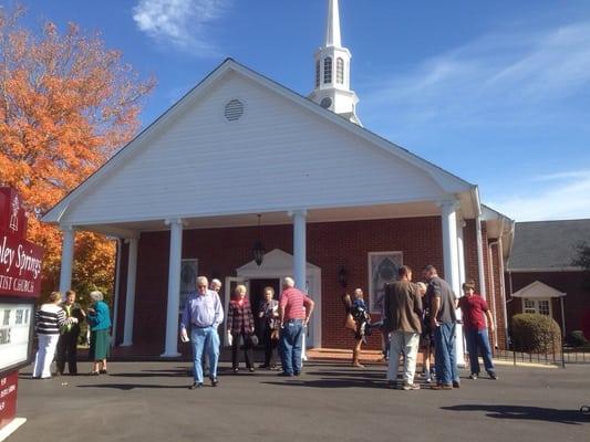 Folks hanging out outside after a service.