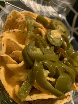 Nachos with lots of piping hot nacho cheese sauce and of course, xtra jalapeños