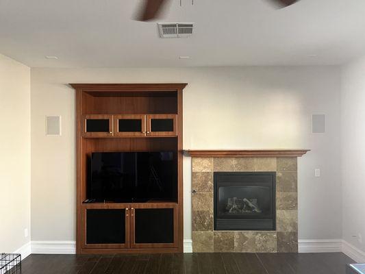 Before photo with fireplace and built in wall unit.