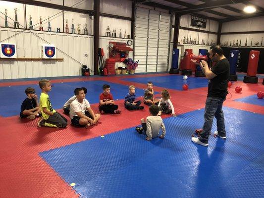 Master Nick teaching the kids gun safety and how to shoot the different nerf guns