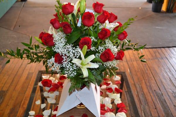 Floral vase with 24 red roses, with lilies, million star and green leaves..  Order at 267 909 9793.