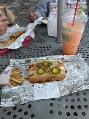 Value combo 2 Made To Order Hot Dogs, fries and a peach slushie.