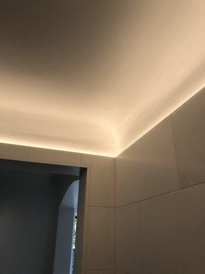 Cove LED lighting around bathroom tile.