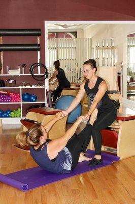 Some assistance for a beginner Pilates client.