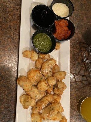 Cheese curds with Parmesan cheese, balsamic vinaigrette, tomato paste and pesto. SO GOOD!!!