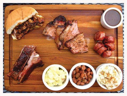 Mesquite smoked Texas style beef brisket, hickory smoked Alabama pulled pork, hickory and pecan smoked Memphis ribs and a sampling of sides.