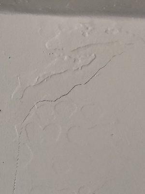 The stress crack goes half way down the wall up to ceiling. Before fixed.