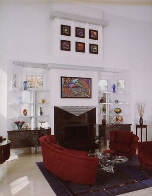 This funky contemporary living room showcases an lighted stainless steel mantel.