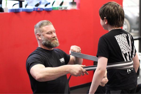 My youngest son receiving his belt