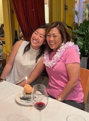 A very happy birthday girl wearing a specialty, Hawaiian lei, designed by John Yip.