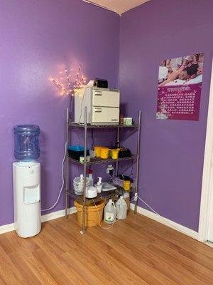 Our supply station which stores our massage creams and oils plus our towel warmer.