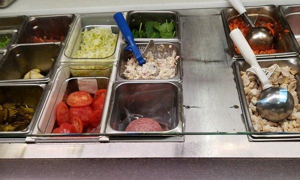 lots of toppings at the deli station