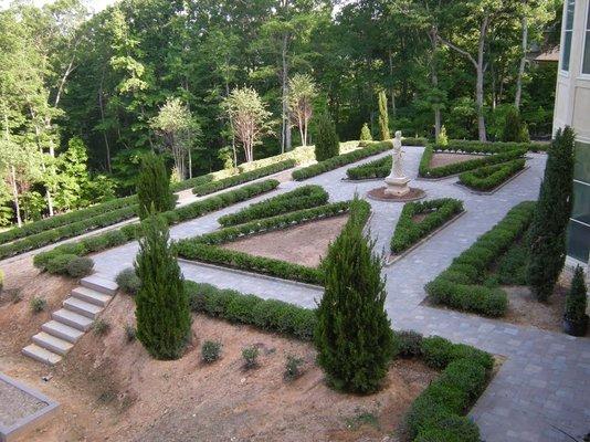 Envisions took a bare terrace of red clay and built the frame work for this formal rose garden using concrete interlocking pavers.