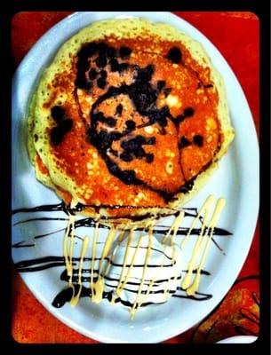 Chocolate chip pancakes with whip cream, fudge and condensed milk drizzle.