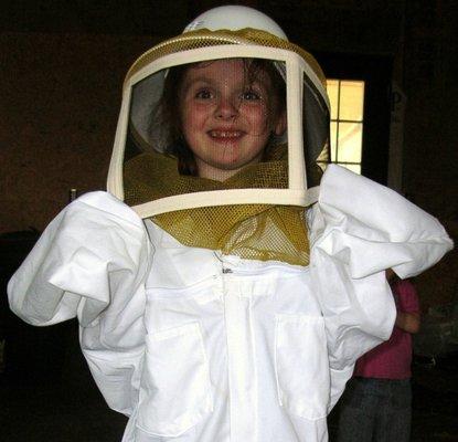 Our now teenage daughter preparing for her first trip to the bee yard.