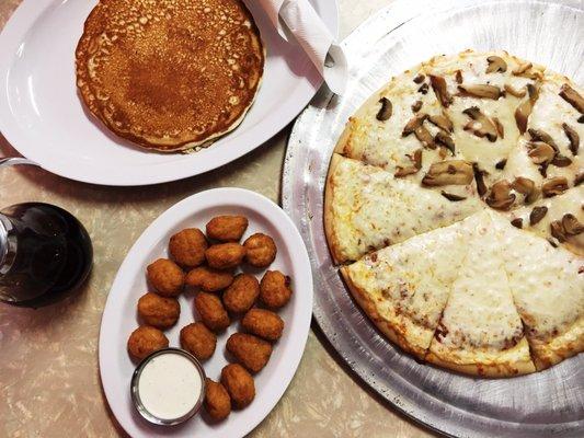 1/2 cheese, 1/2 mushroom pizza, a single pancake, corn nuggets.