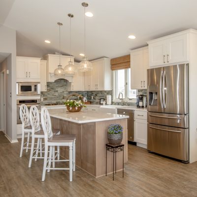 White and driftwood colored cabinetry create a peaceful pallet in this remodeled kitchen.